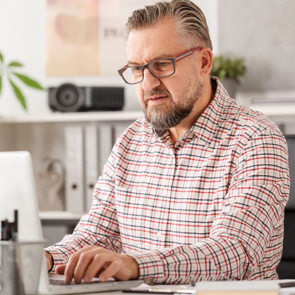 Man filling out forms on a computer